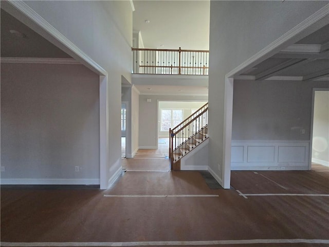 foyer entrance with dark hardwood / wood-style flooring and ornamental molding