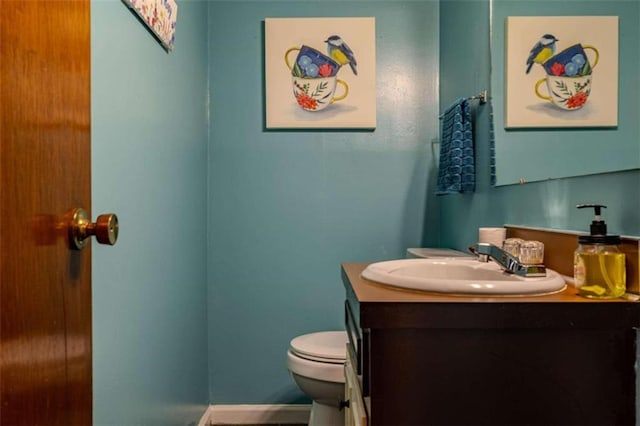 bathroom with toilet and vanity