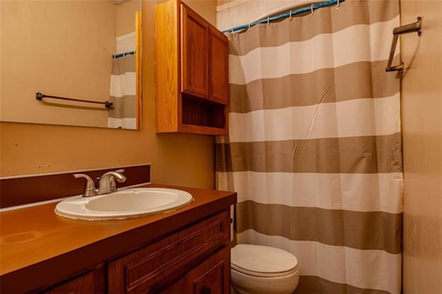 bathroom featuring vanity, toilet, and curtained shower