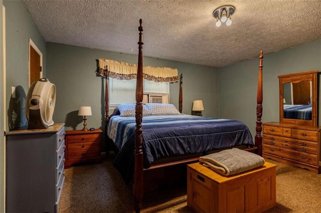 bedroom featuring dark colored carpet and a textured ceiling