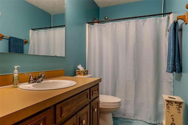 bathroom with a textured ceiling, vanity, toilet, and a shower with curtain