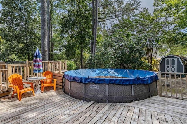 wooden terrace featuring a storage shed and a covered pool