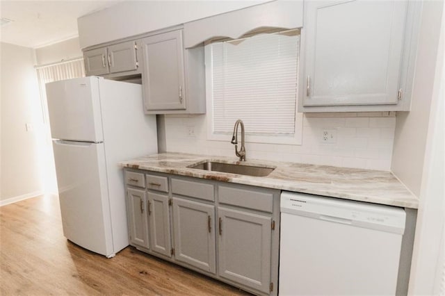 kitchen featuring gray cabinets, white appliances, sink, and light hardwood / wood-style flooring