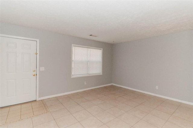 empty room with light tile patterned flooring