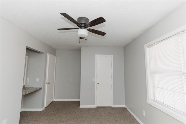 unfurnished bedroom featuring light carpet and ceiling fan