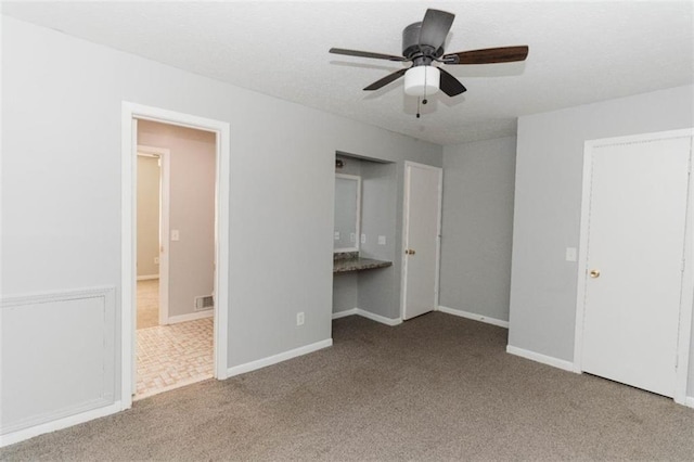 unfurnished bedroom featuring carpet flooring and ceiling fan