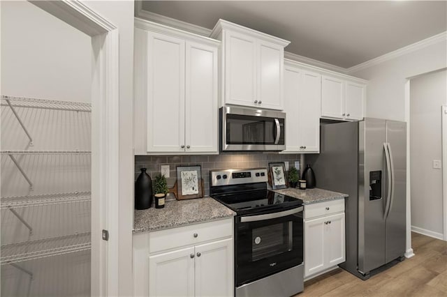 kitchen featuring appliances with stainless steel finishes, light hardwood / wood-style floors, white cabinets, and light stone countertops