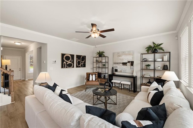 living room with ceiling fan, ornamental molding, and hardwood / wood-style floors