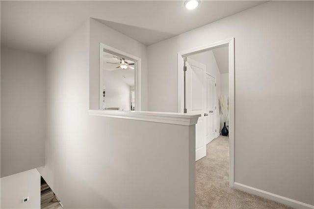 hallway with light colored carpet