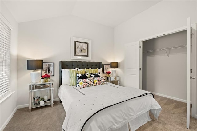 bedroom with lofted ceiling, a closet, and light carpet