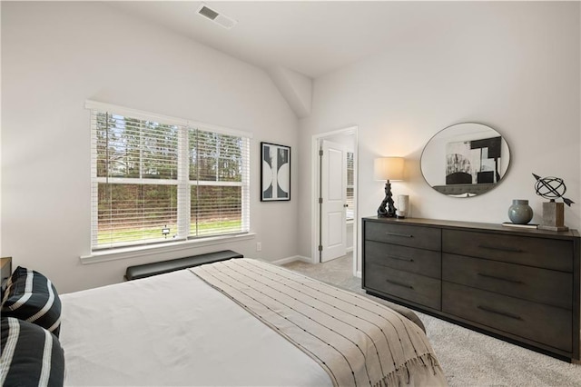 carpeted bedroom with lofted ceiling