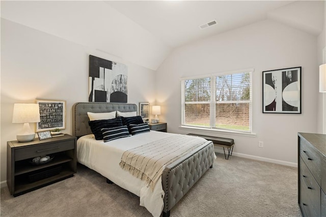 bedroom with light colored carpet and lofted ceiling