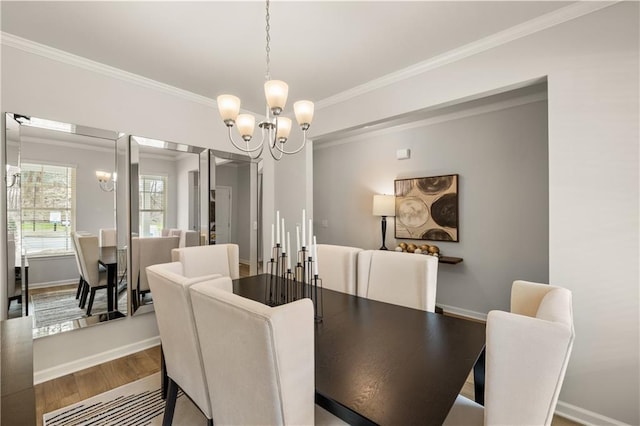 dining room featuring wood-type flooring, crown molding, and a notable chandelier