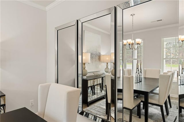 dining room featuring ornamental molding and a notable chandelier