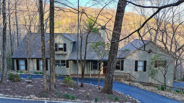 view of front of house with roof with shingles