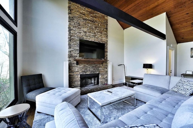 living room with high vaulted ceiling, wood finished floors, beam ceiling, and a stone fireplace