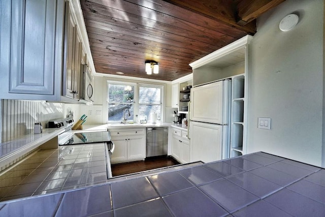 kitchen with stainless steel appliances, tile countertops, a sink, open shelves, and wooden ceiling