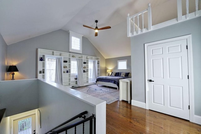 bedroom with high vaulted ceiling, wood finished floors, and ceiling fan