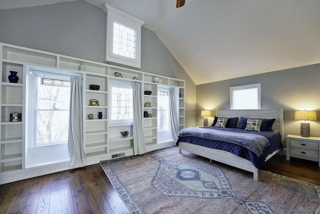 bedroom featuring wood-type flooring, high vaulted ceiling, and visible vents