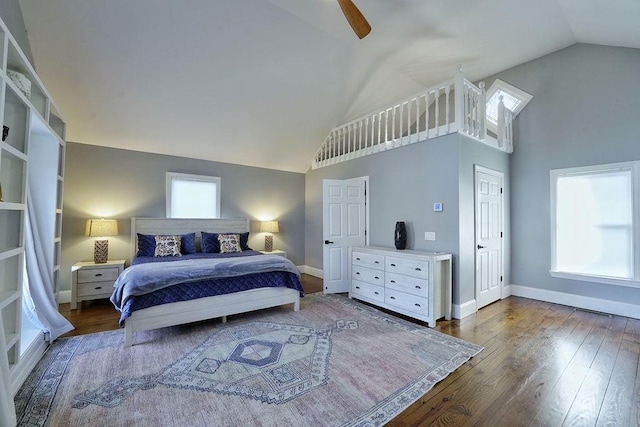 bedroom featuring baseboards, high vaulted ceiling, ceiling fan, and wood-type flooring