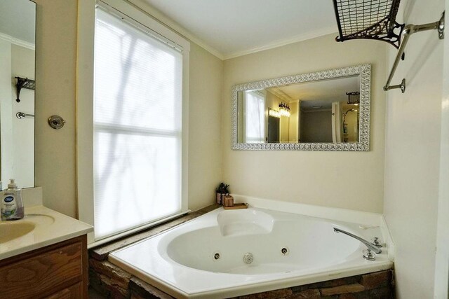 full bathroom featuring a tub with jets, crown molding, and vanity