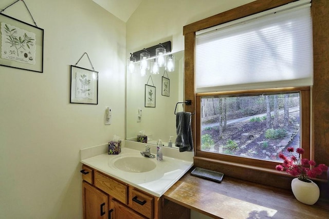 bathroom with vaulted ceiling and vanity