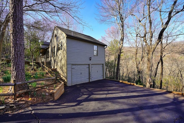 garage featuring aphalt driveway