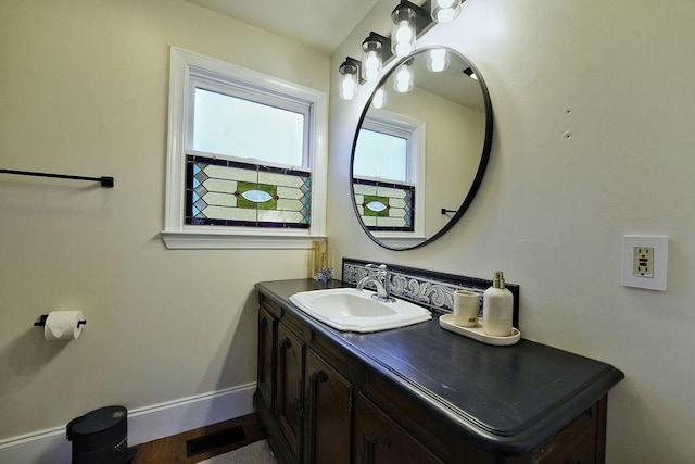 bathroom with baseboards, visible vents, and vanity