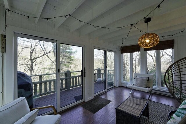 sunroom featuring hardwood / wood-style floors and beamed ceiling
