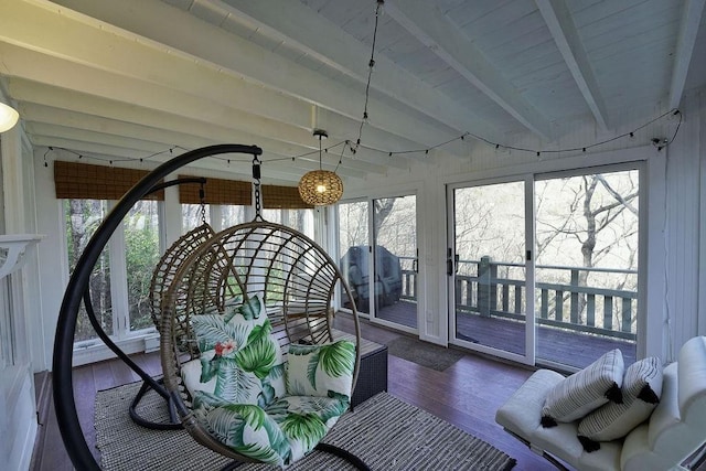 sunroom with beamed ceiling and a wealth of natural light