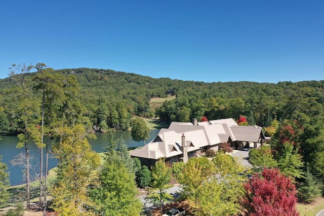 bird's eye view with a water view and a wooded view