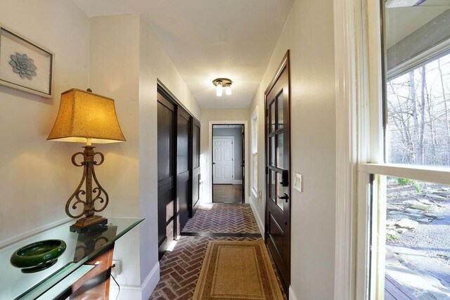 corridor with brick floor and french doors