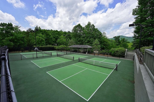 view of tennis court with fence