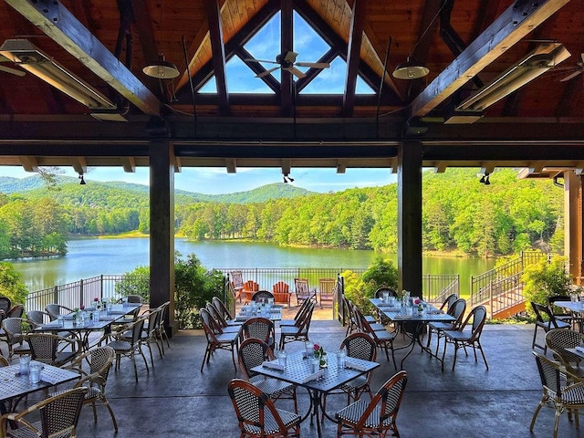 view of patio / terrace featuring a water view, outdoor dining area, and a gazebo