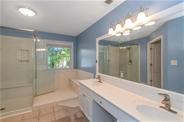 bathroom featuring vanity, walk in shower, and tile patterned floors