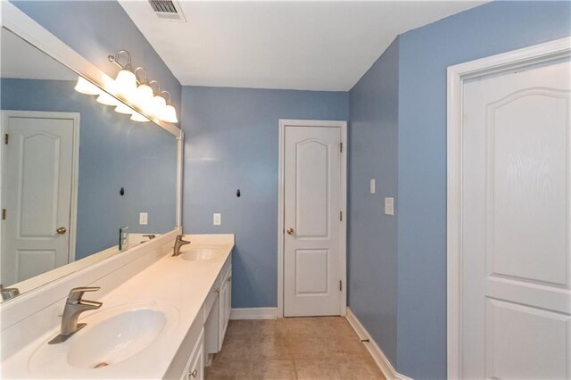 bathroom with tile patterned floors and vanity