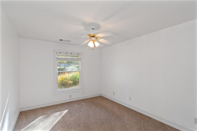 unfurnished room with ceiling fan and light colored carpet