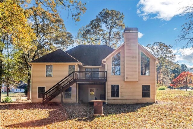 rear view of house featuring a wooden deck