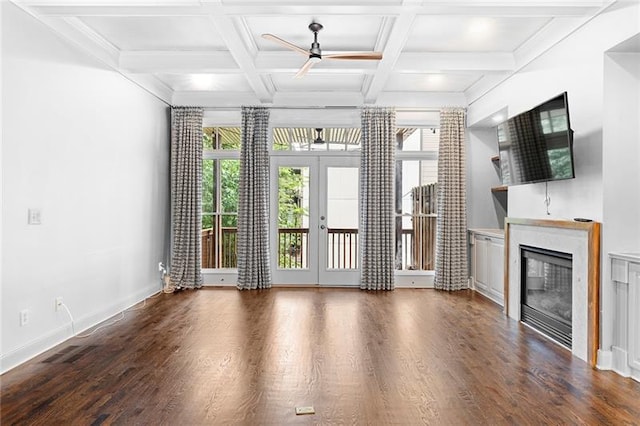 unfurnished living room featuring dark hardwood / wood-style floors, coffered ceiling, beam ceiling, and french doors