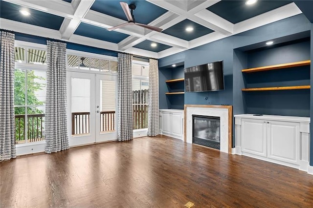 unfurnished living room with built in shelves, french doors, coffered ceiling, dark hardwood / wood-style floors, and beamed ceiling