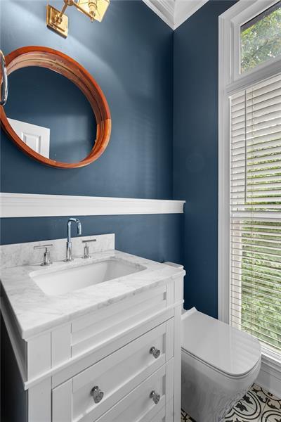 bathroom featuring crown molding, vanity, and toilet