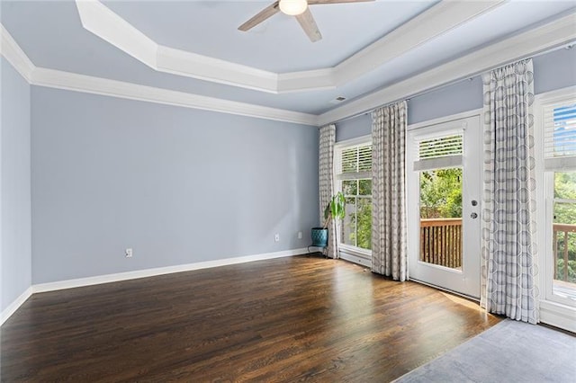 spare room featuring hardwood / wood-style flooring, crown molding, ceiling fan, and a tray ceiling