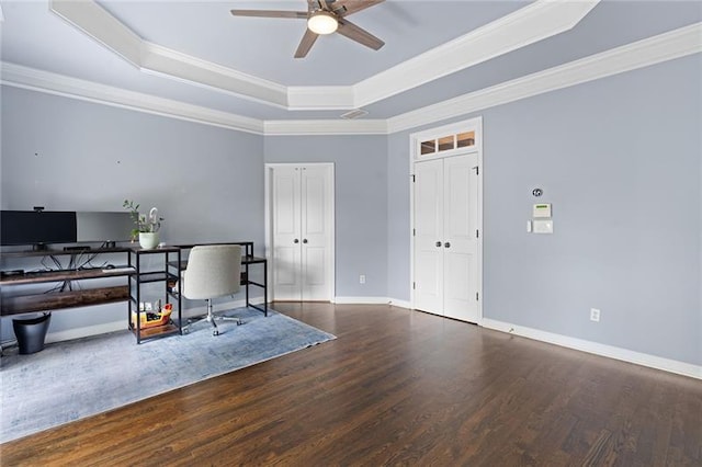 office area with crown molding, dark hardwood / wood-style floors, a raised ceiling, and ceiling fan