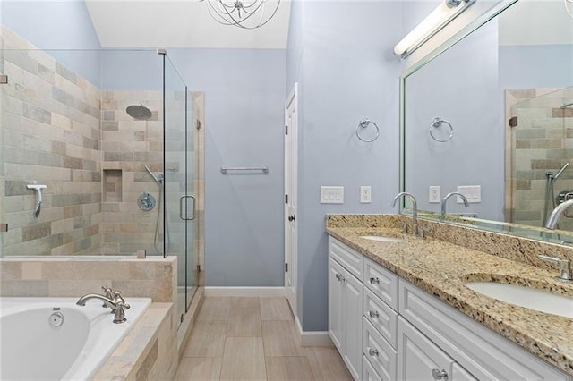 bathroom featuring vanity and independent shower and bath