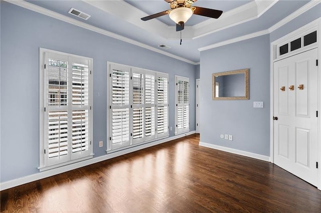 entryway with a tray ceiling, crown molding, dark wood-type flooring, and ceiling fan