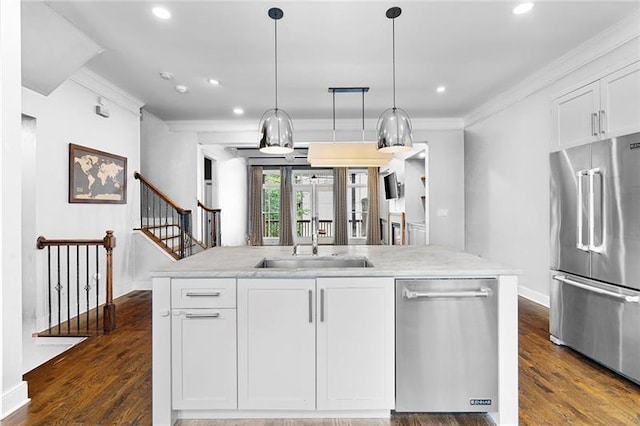 kitchen featuring pendant lighting, sink, white cabinets, and appliances with stainless steel finishes