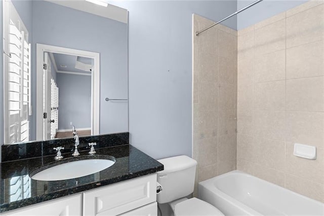 full bathroom with vanity, tiled shower / bath combo, and toilet