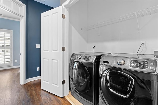 laundry area featuring dark wood-type flooring and washer and dryer