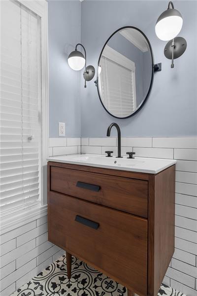 bathroom with tile patterned flooring, vanity, and ornamental molding