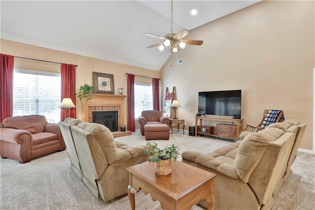 carpeted living room featuring ceiling fan, a fireplace, and high vaulted ceiling